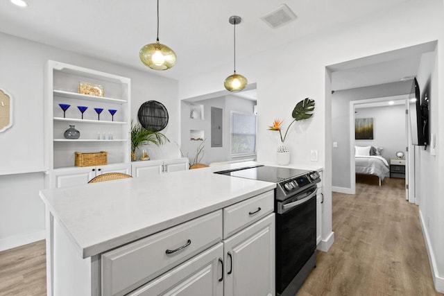 kitchen with electric panel, light wood-type flooring, decorative light fixtures, electric range oven, and white cabinetry