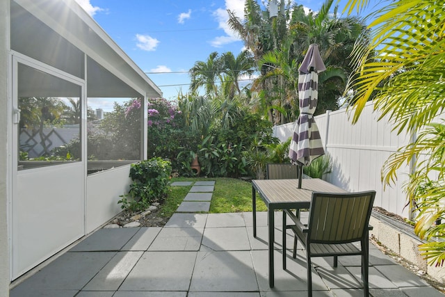 view of patio / terrace featuring a sunroom