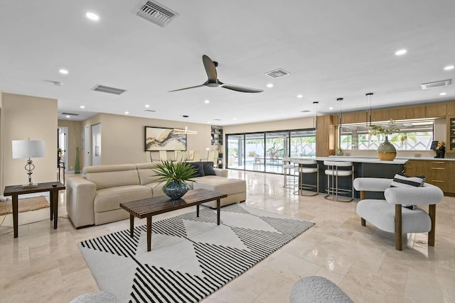 living room featuring ceiling fan and plenty of natural light