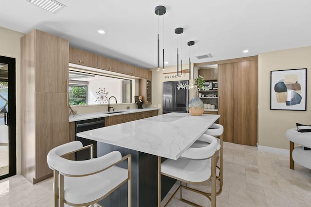 kitchen featuring stainless steel refrigerator, sink, a center island, hanging light fixtures, and black dishwasher