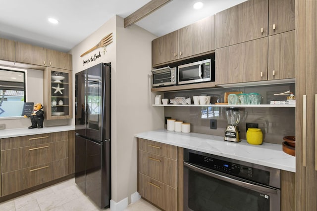 kitchen with light stone counters and stainless steel appliances