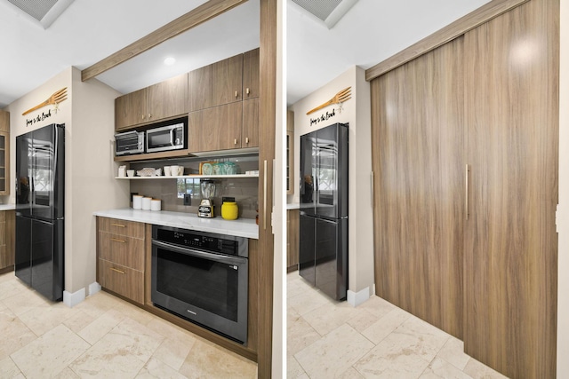 kitchen featuring beam ceiling and appliances with stainless steel finishes