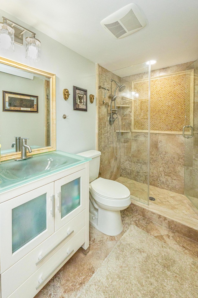 bathroom featuring toilet, vanity, and walk in shower