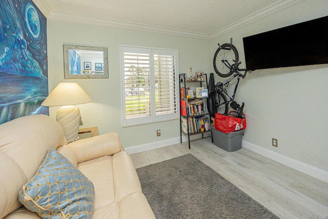 sitting room featuring light hardwood / wood-style floors and ornamental molding