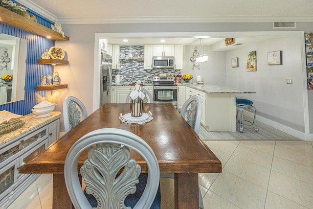 tiled dining space with crown molding