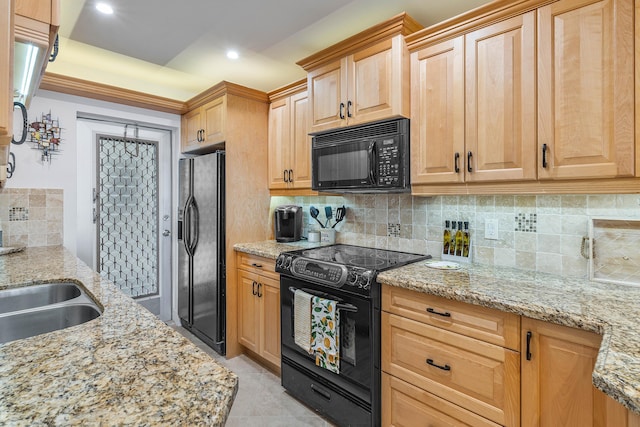 kitchen featuring decorative backsplash, sink, black appliances, and light stone counters