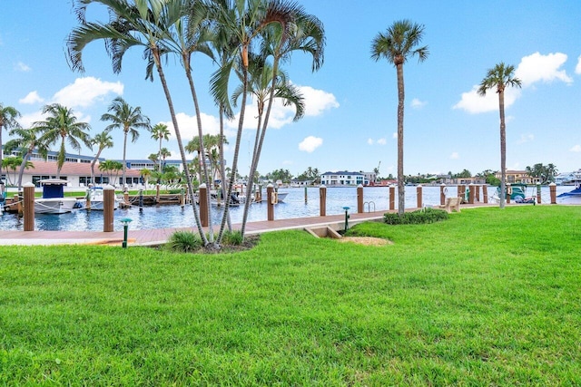 dock area featuring a water view and a lawn