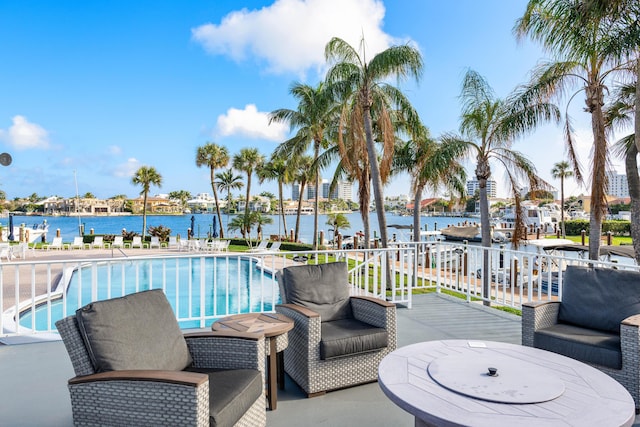 view of swimming pool featuring a deck with water view