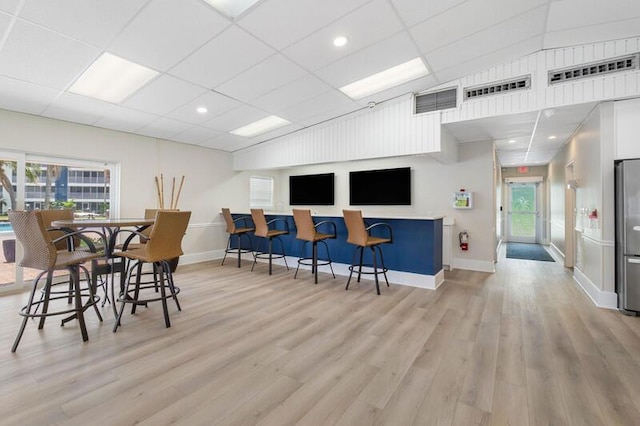 interior space with light wood-type flooring and stainless steel refrigerator