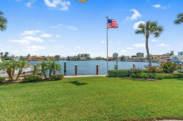 view of dock featuring a lawn and a water view