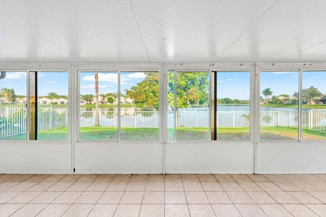 unfurnished sunroom with a water view