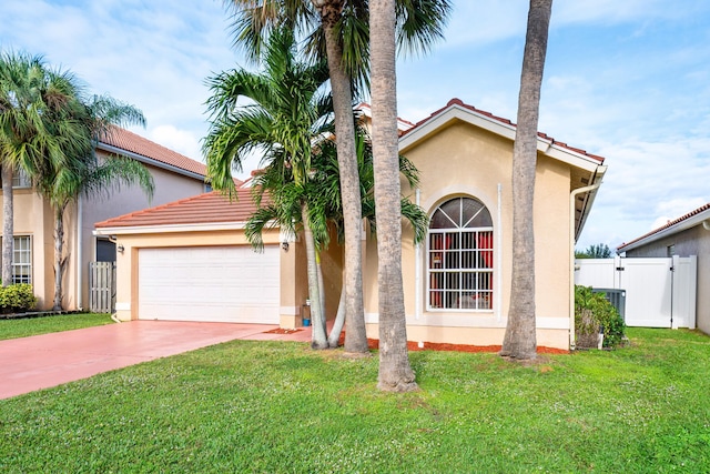 mediterranean / spanish house with a front lawn and a garage