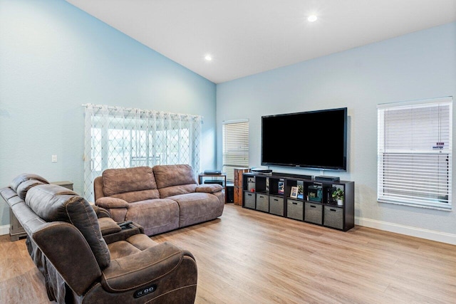 living room with light hardwood / wood-style flooring and lofted ceiling