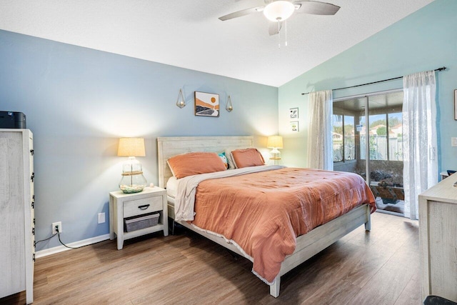 bedroom featuring access to outside, ceiling fan, wood-type flooring, and lofted ceiling