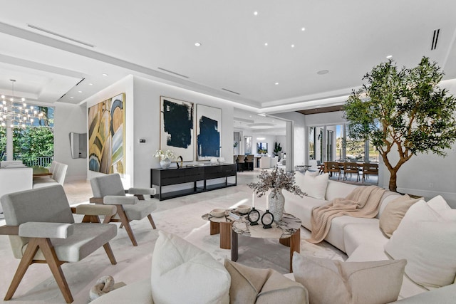 living room with a chandelier and a tray ceiling