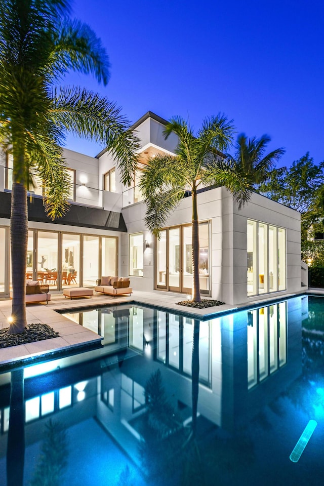 view of swimming pool featuring an outdoor living space and a patio