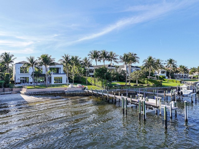 dock area featuring a lawn and a water view