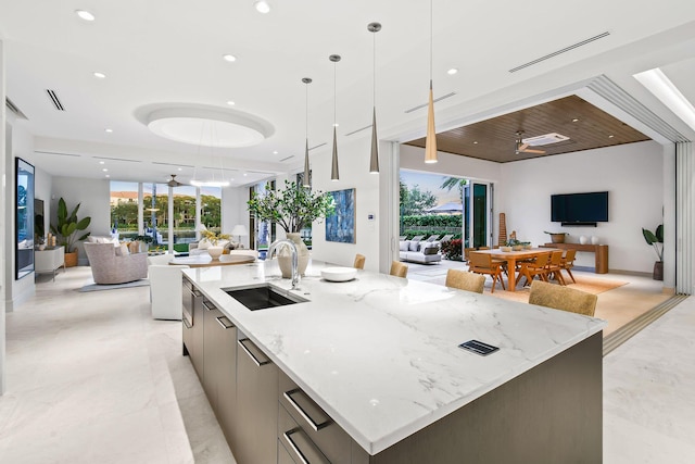 kitchen with pendant lighting, a large island, gray cabinets, and sink