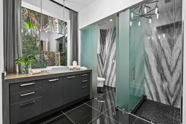 bathroom featuring vanity, toilet, and an enclosed shower