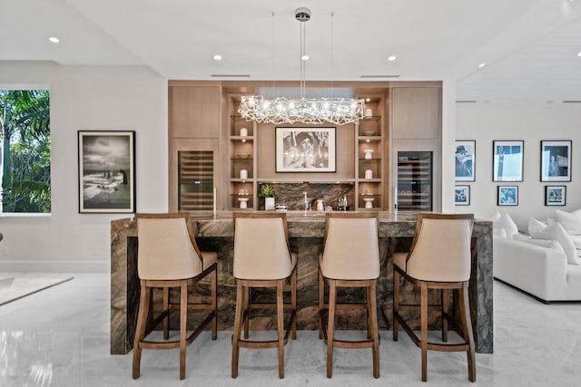 bar with built in shelves, beverage cooler, and pendant lighting