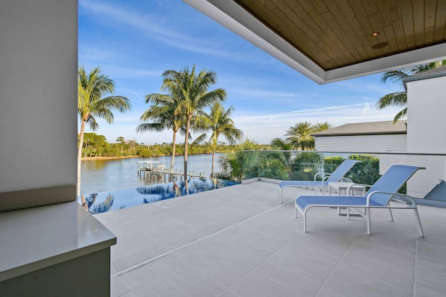 view of patio featuring a water view and a dock