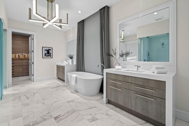 bathroom featuring a bath, vanity, and an inviting chandelier