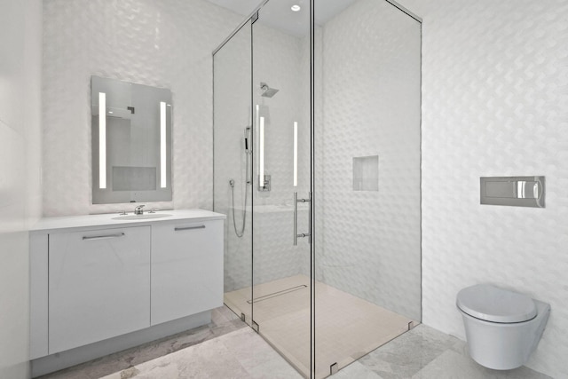 bathroom with toilet, vanity, and tiled shower