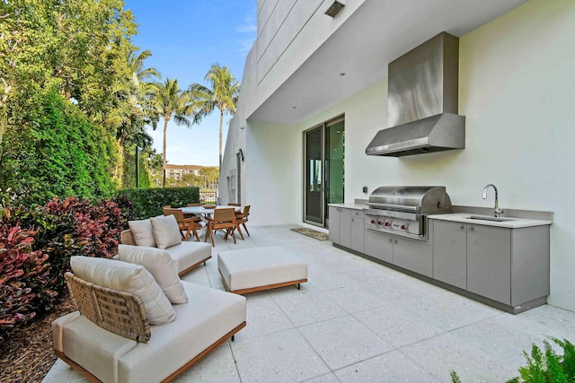 view of patio / terrace featuring sink, an outdoor kitchen, and a grill