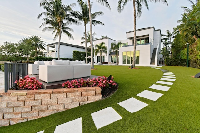 view of yard featuring an outdoor living space and a balcony