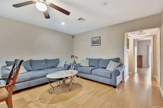 living room with ceiling fan and light wood-type flooring