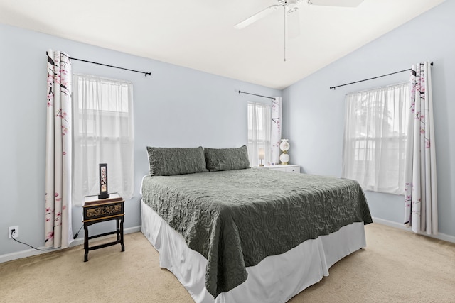 carpeted bedroom with multiple windows, ceiling fan, and lofted ceiling