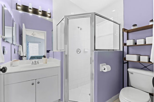 bathroom with walk in shower, ceiling fan, vanity, and toilet