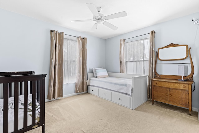 bedroom with ceiling fan and light carpet