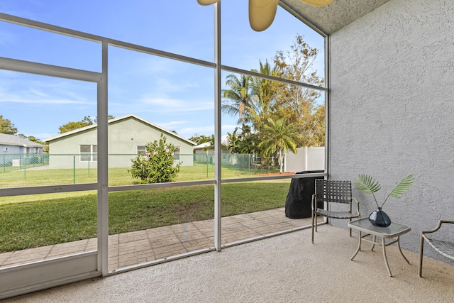 unfurnished sunroom with ceiling fan and a healthy amount of sunlight