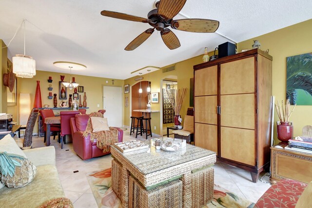 kitchen with pendant lighting, ceiling fan, a center island, and light tile patterned floors