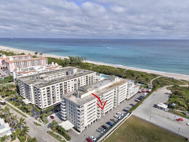 drone / aerial view featuring a view of the beach and a water view