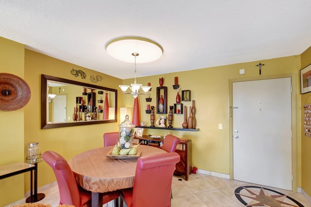 tiled dining area with a notable chandelier