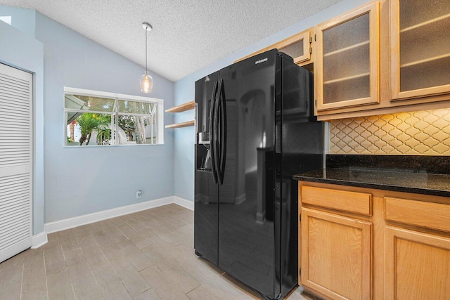 kitchen with vaulted ceiling, decorative backsplash, hanging light fixtures, light hardwood / wood-style floors, and black refrigerator with ice dispenser