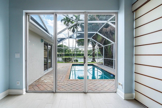 view of swimming pool featuring a lanai and a patio area