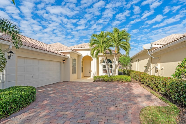 mediterranean / spanish-style house featuring a garage