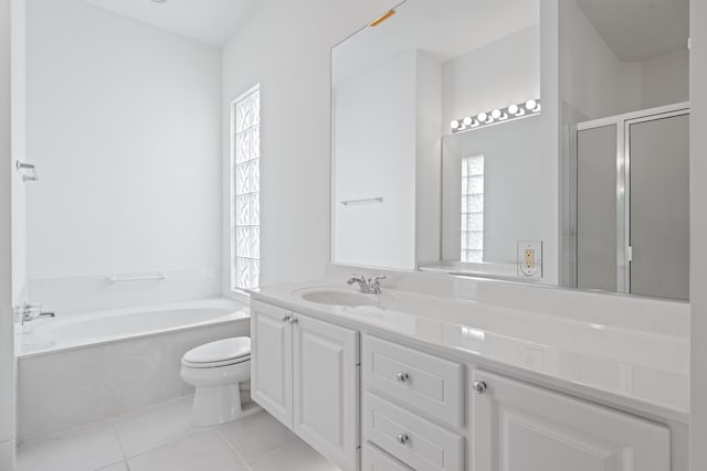 full bathroom with toilet, a healthy amount of sunlight, vanity, and tile patterned floors