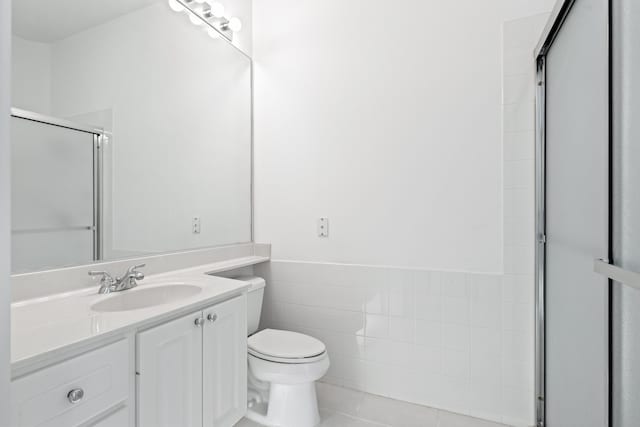 bathroom featuring an enclosed shower, tile patterned flooring, vanity, tile walls, and toilet