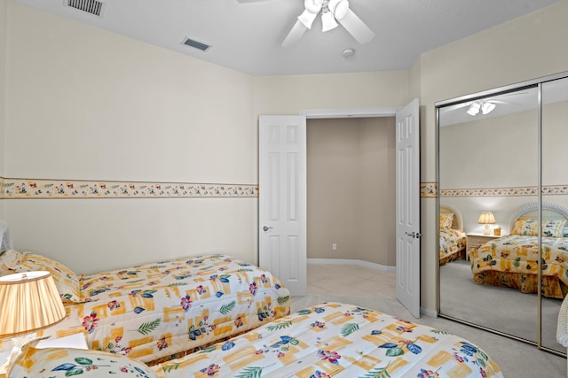 carpeted bedroom featuring a closet and ceiling fan