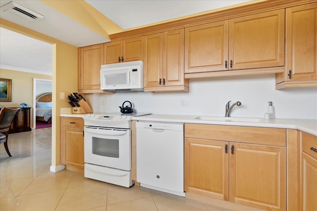 kitchen featuring sink, white appliances, crown molding, and light tile patterned floors