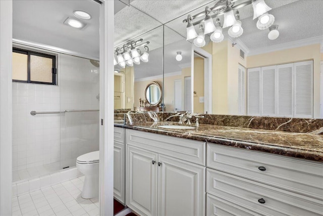 bathroom featuring vanity, a shower with door, tile patterned floors, crown molding, and toilet