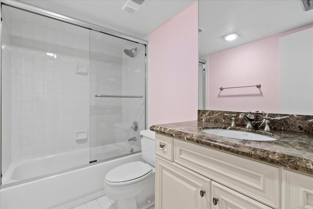 full bathroom with shower / bath combination with glass door, tile patterned floors, vanity, and toilet