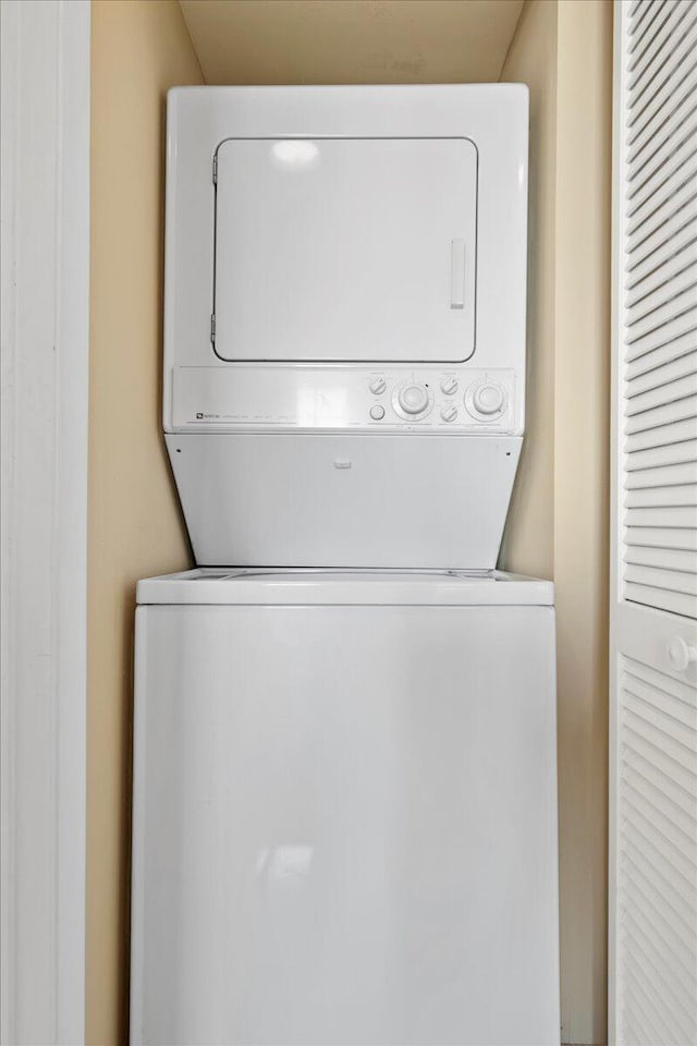 laundry area with stacked washer / dryer