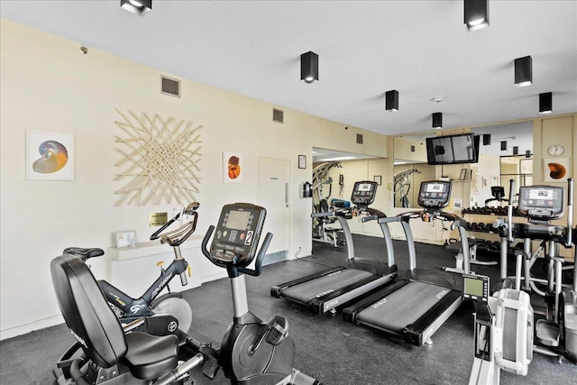 workout area featuring a textured ceiling