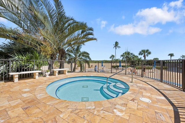 view of swimming pool featuring a patio area and a hot tub