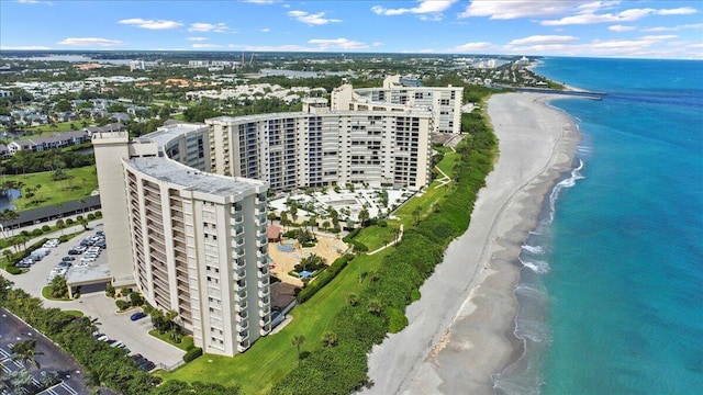 bird's eye view with a water view and a beach view